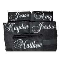 Black custom hand towels with white embroidered monogram names in elegant fonts