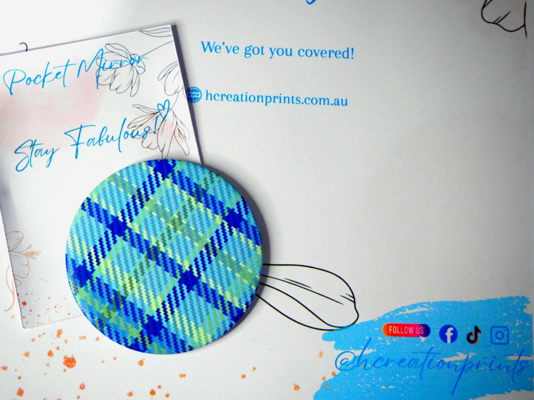 Compact pocket mirror with blue and green plaid design for travel and daily use