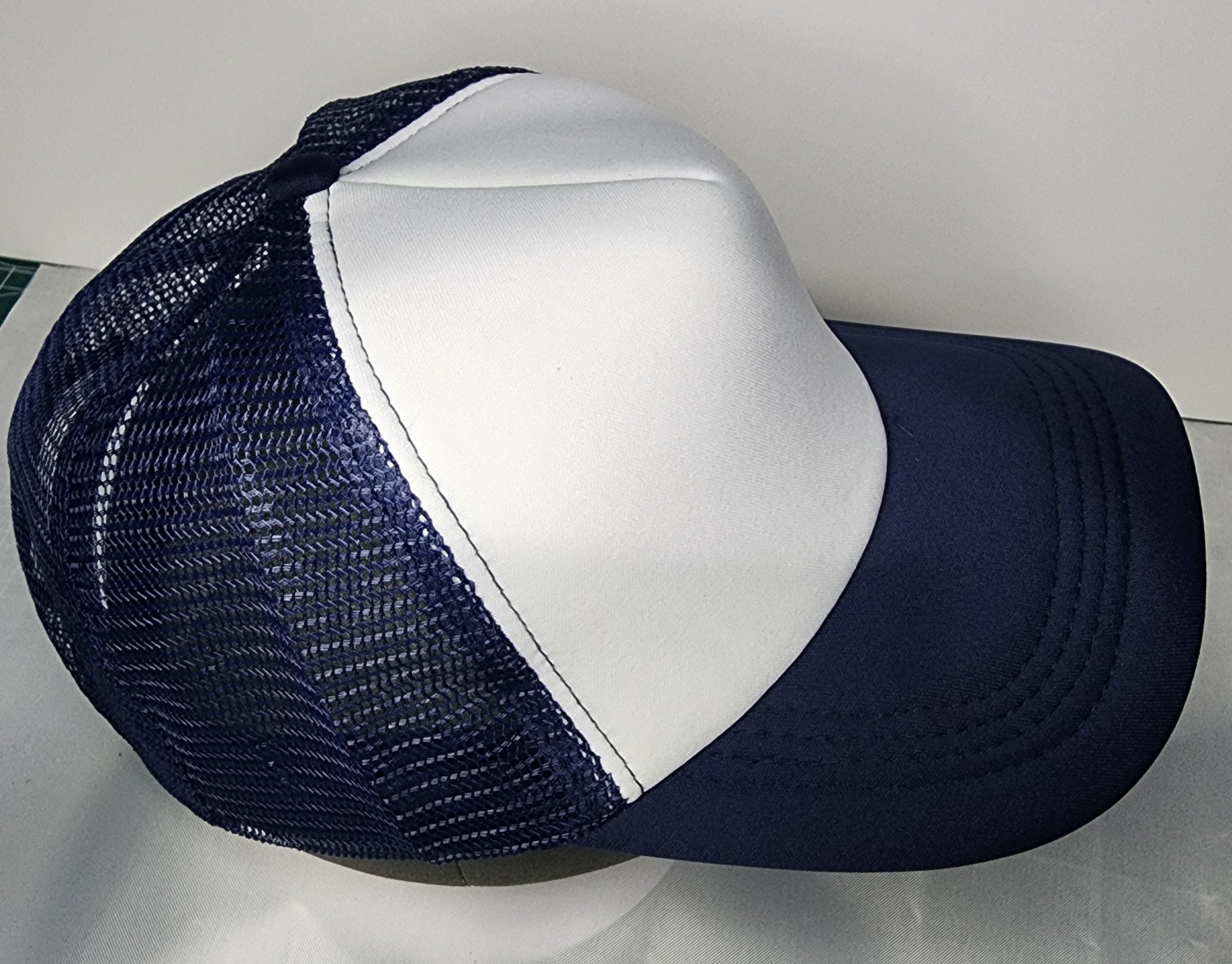 Side view of trucker mesh cap showing breathable foam panel