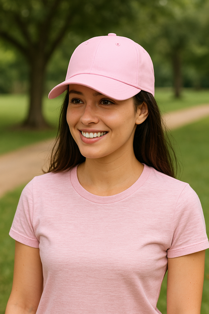Woman wearing a pink cotton twill cap with adjustable fit outdoors