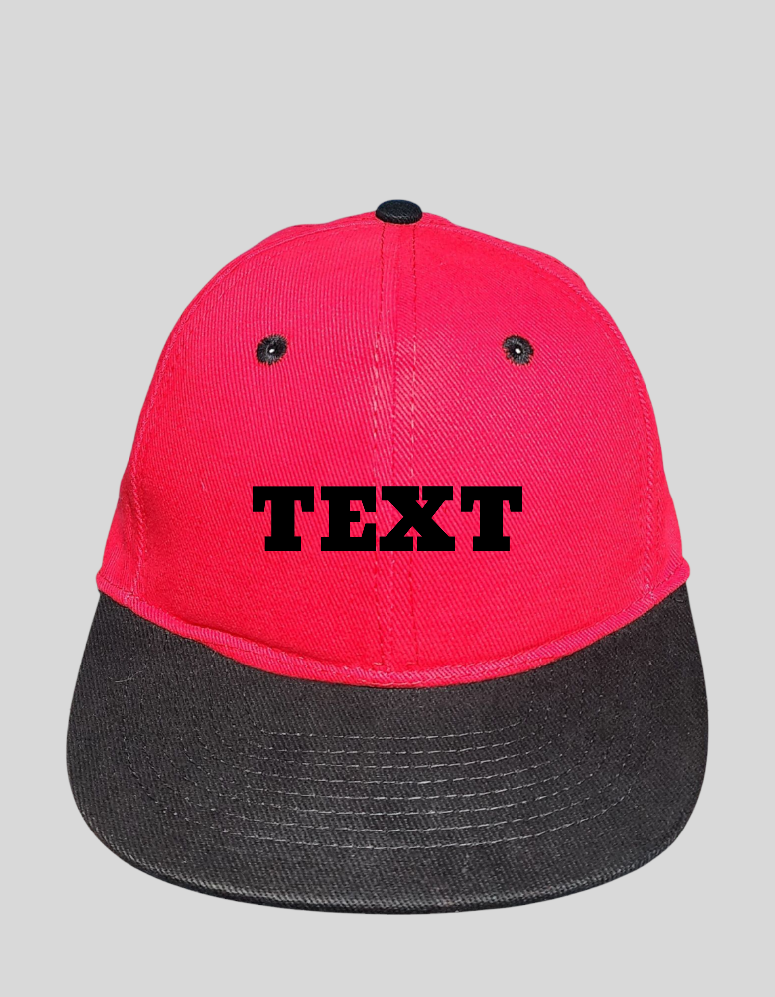 Red and black flat brim cap with custom embroidered text on the front, adjustable snapback closure, and durable cotton material.